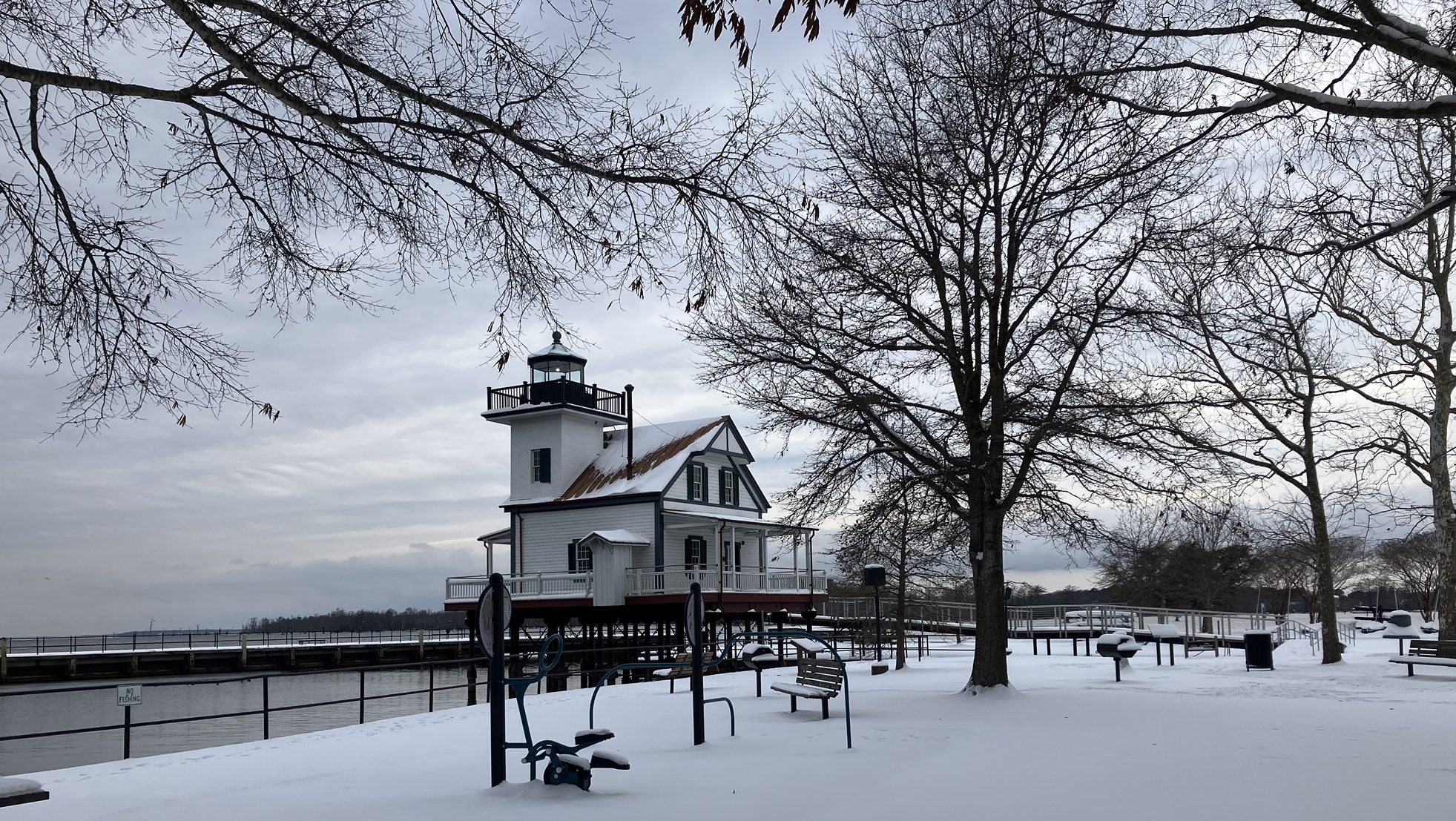 lighthouse and ground covered in snow