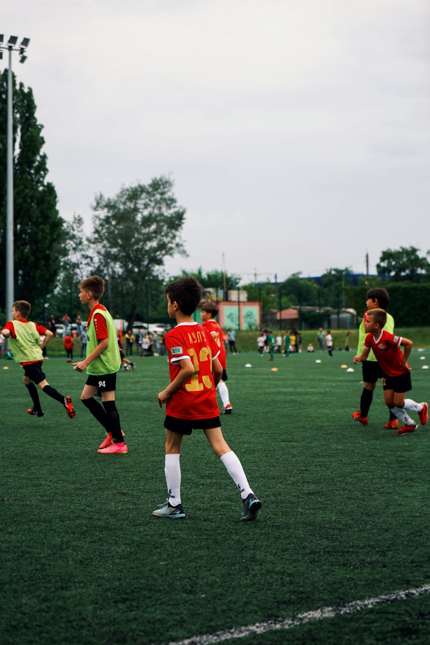 boys playing soccer on pitch